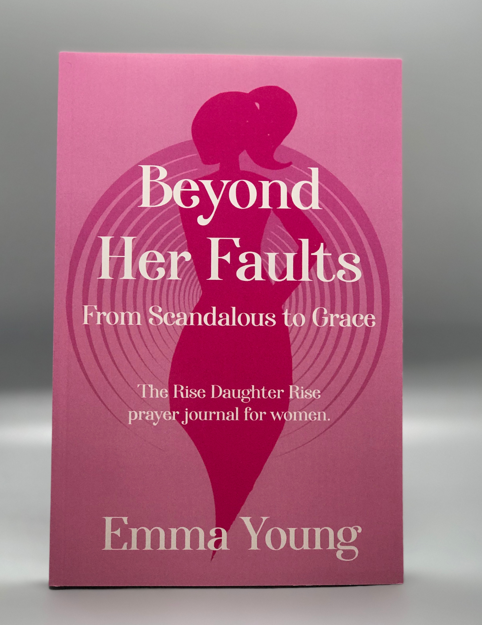 Frontal view of pink book cover with centered woman's silhouette.