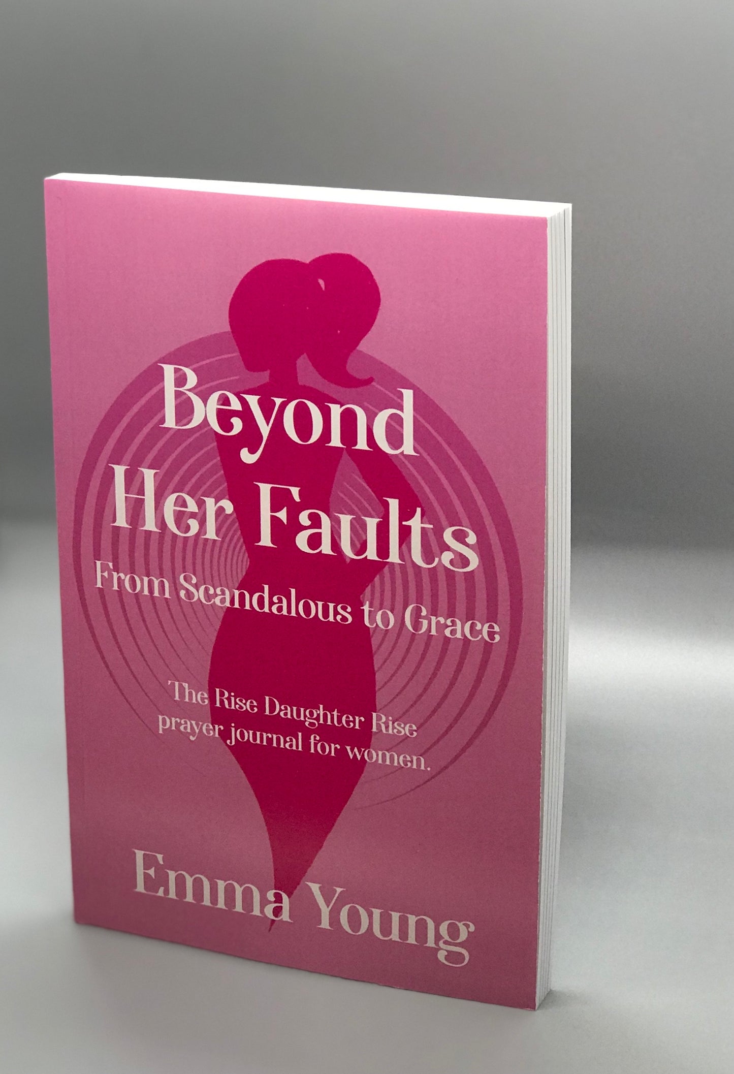 Side view of pink book cover with centered woman's silhouette.